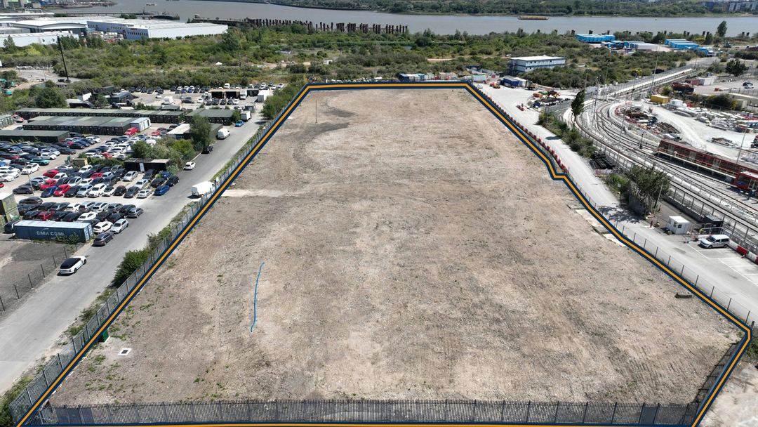 Aerial photo of a 4.01 acre open storage plot at Beckton Gas Works, fenced and levelled, with the River Thames behind